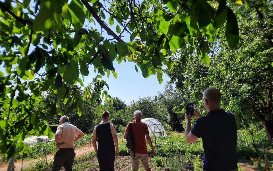 Mensen bezoeken een moestuin.